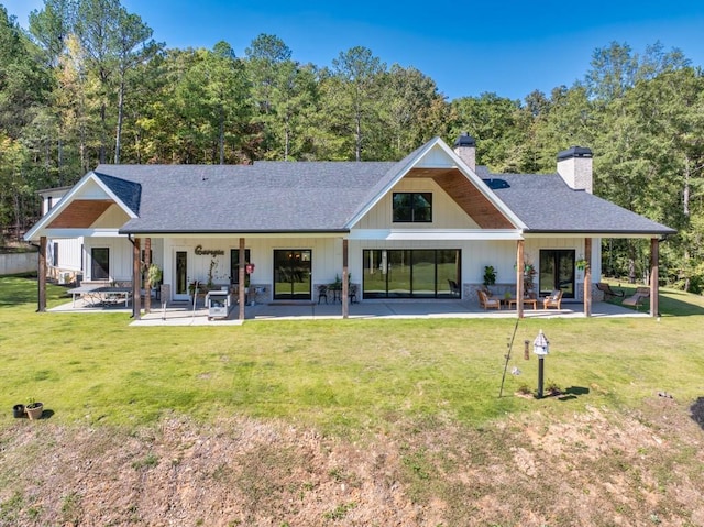 441 Pumpkinvine Rd, Acworth, GA 30101 - rear view of house with a shingled roof, a patio area, a lawn, and a chimney