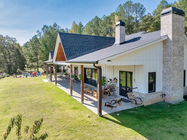 441 Pumpkinvine Rd, Acworth, GA 30101 - rear view of house with a chimney, a patio, and roof with shingles