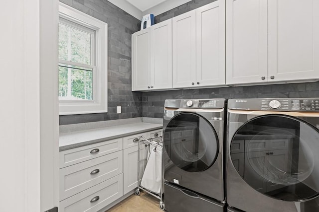 441 Pumpkinvine Rd, Acworth, GA 30101 - laundry room featuring separate washer and dryer and cabinet space
