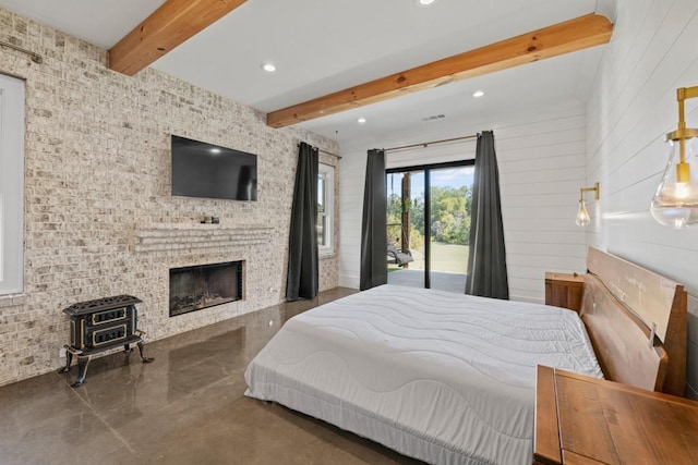 441 Pumpkinvine Rd, Acworth, GA 30101 - bedroom with beamed ceiling, recessed lighting, concrete floors, access to exterior, and a wood stove