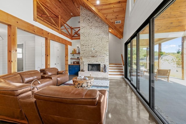 441 Pumpkinvine Rd, Acworth, GA 30101 - living area with visible vents, a large fireplace, finished concrete floors, wooden ceiling, and high vaulted ceiling