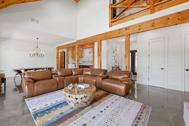 441 Pumpkinvine Rd, Acworth, GA 30101 - living area with a high ceiling, visible vents, a notable chandelier, and concrete floors