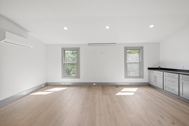 441 Pumpkinvine Rd, Acworth, GA 30101 - unfurnished room featuring light wood-style flooring, plenty of natural light, and a wall mounted air conditioner