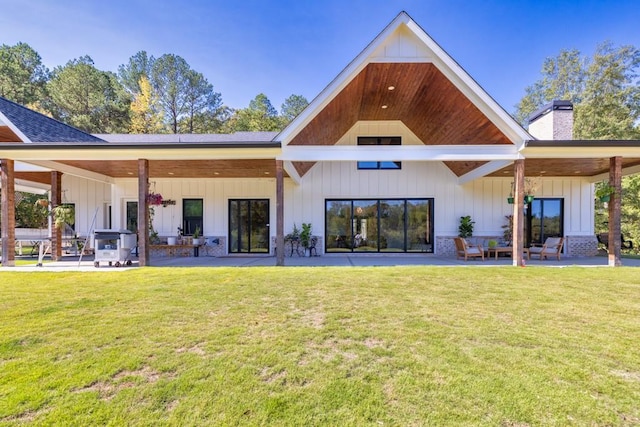 441 Pumpkinvine Rd, Acworth, GA 30101 - back of house featuring a patio, a yard, board and batten siding, and a chimney