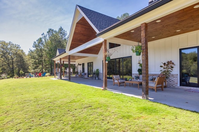 441 Pumpkinvine Rd, Acworth, GA 30101 - back of property featuring a lawn, board and batten siding, a patio, and roof with shingles
