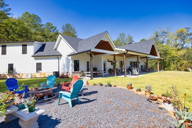 441 Pumpkinvine Rd, Acworth, GA 30101 - rear view of house featuring a patio, a yard, a fire pit, roof with shingles, and board and batten siding