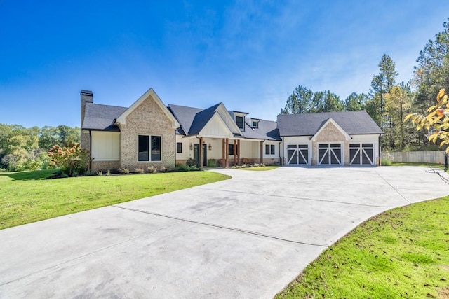 441 Pumpkinvine Rd, Acworth, GA 30101 - view of front of house featuring brick siding, board and batten siding, a front lawn, a chimney, and driveway