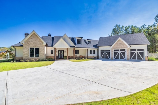 441 Pumpkinvine Rd, Acworth, GA 30101 - view of front of house featuring a front lawn, concrete driveway, board and batten siding, and a chimney