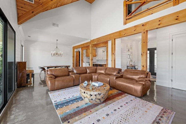 441 Pumpkinvine Rd, Acworth, GA 30101 - living area featuring visible vents, a notable chandelier, concrete flooring, and high vaulted ceiling