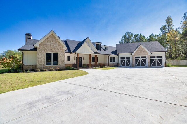 441 Pumpkinvine Rd, Acworth, GA 30101 - view of front of property featuring a front yard, a chimney, concrete driveway, board and batten siding, and brick siding