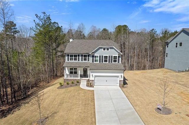 view of front facade with stone siding, covered porch, a garage, concrete driveway, and a front lawn