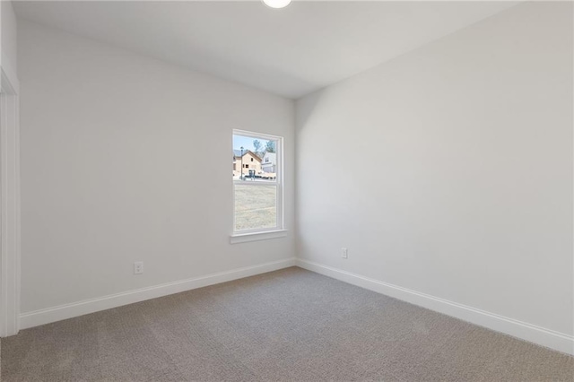 carpeted empty room with baseboards