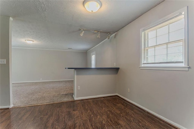 2783 Bicentennial Dr, Stone Mountain, GA 30087 - unfurnished room featuring a textured ceiling, wood finished floors, crown molding, and track lighting