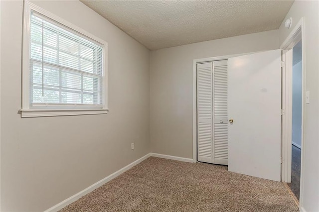 2783 Bicentennial Dr, Stone Mountain, GA 30087 - unfurnished bedroom with carpet flooring, a closet, and a textured ceiling
