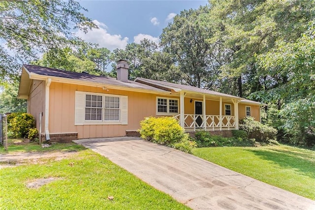 2783 Bicentennial Dr, Stone Mountain, GA 30087 - ranch-style house featuring a porch, a chimney, and a front lawn