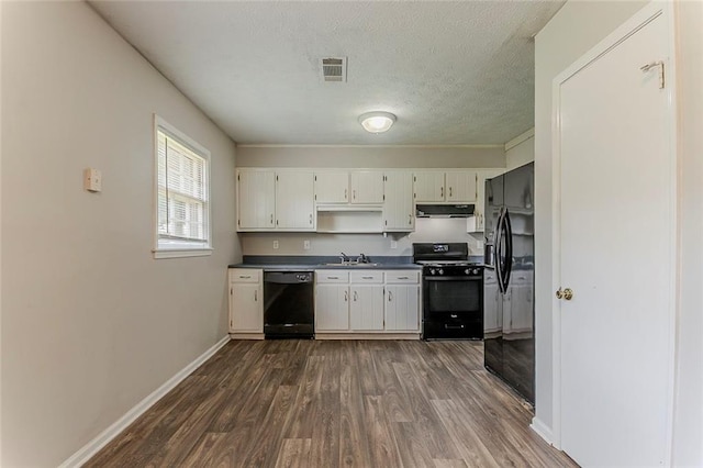 2783 Bicentennial Dr, Stone Mountain, GA 30087 - kitchen featuring black appliances, dark wood-style flooring, dark countertops, under cabinet range hood, and a textured ceiling
