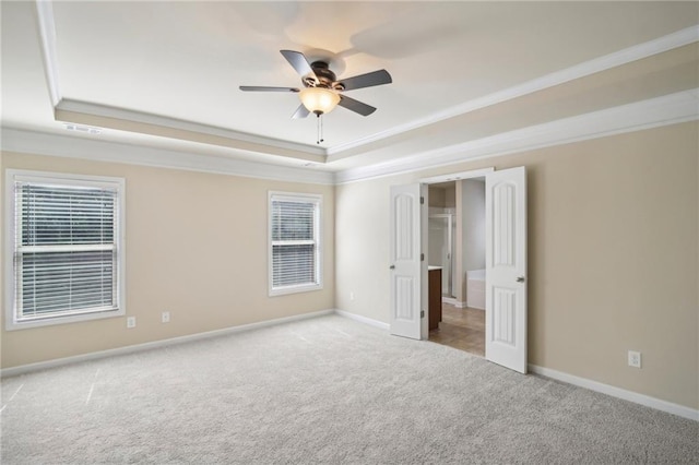 unfurnished bedroom featuring baseboards, visible vents, a raised ceiling, and carpet flooring