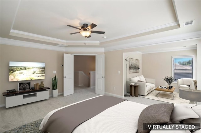 bedroom featuring carpet, visible vents, a tray ceiling, and ornamental molding