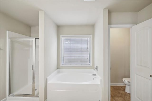 full bathroom with a garden tub, toilet, baseboards, tile patterned floors, and a stall shower