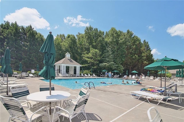 community pool featuring fence and a patio