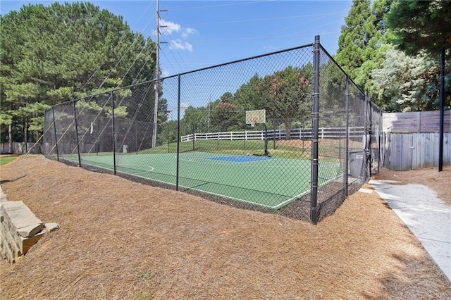 view of basketball court with community basketball court and fence