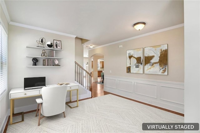 home office with arched walkways, a decorative wall, a wainscoted wall, wood finished floors, and crown molding