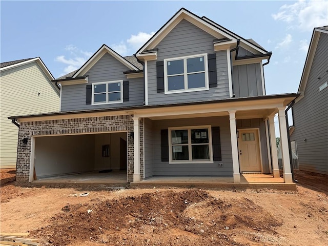 333 Ridge Pointe Dr, Athens, GA 30606 - view of front facade with covered porch, a garage, driveway, and board and batten siding