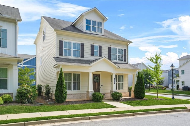 traditional style home featuring a porch and a shingled roof
