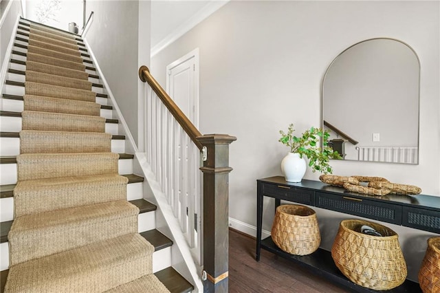 stairway featuring baseboards and wood finished floors