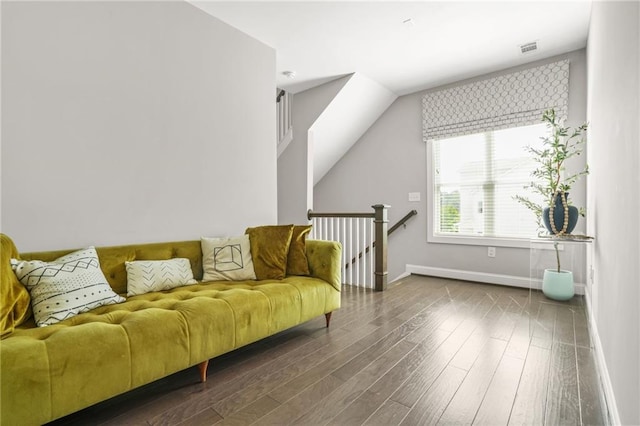 living area with baseboards, an upstairs landing, dark wood finished floors, and visible vents