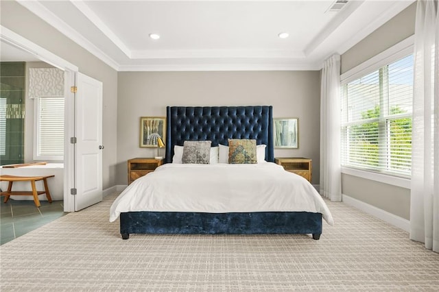 bedroom with a tray ceiling, visible vents, baseboards, and carpet