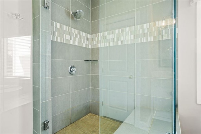full bath featuring tiled shower