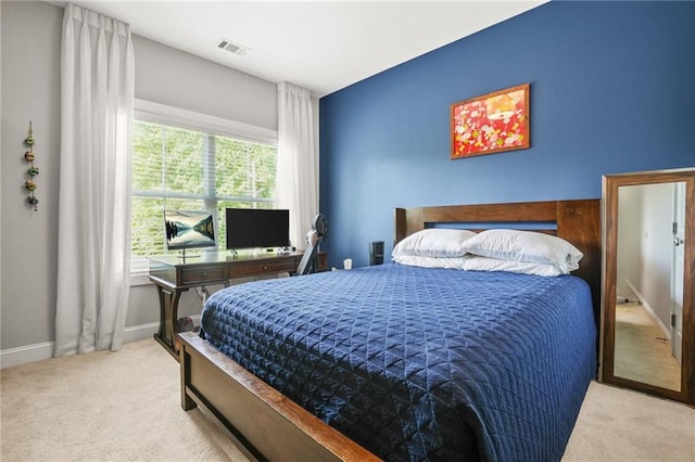 carpeted bedroom featuring visible vents and baseboards