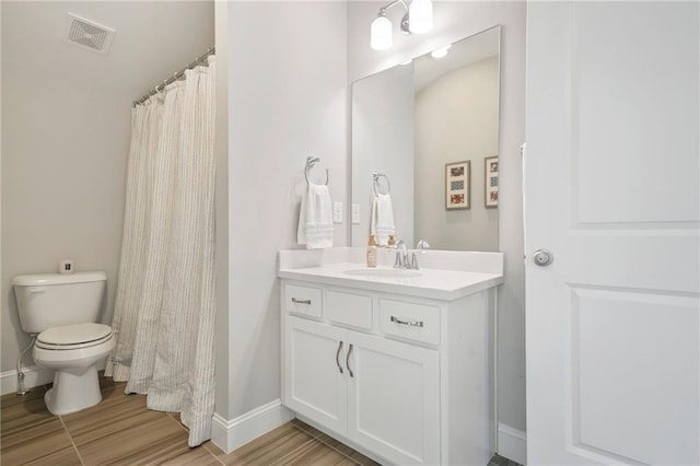 full bathroom featuring visible vents, wood finished floors, baseboards, vanity, and toilet