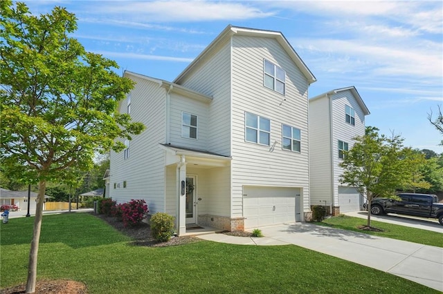 view of front of house featuring an attached garage, driveway, and a front lawn
