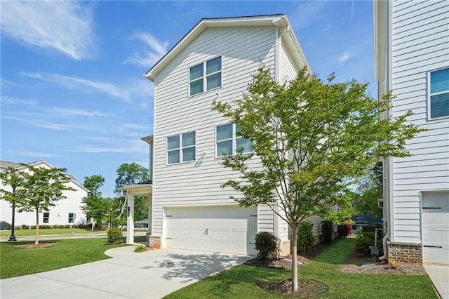 view of front of home with an attached garage, driveway, and a front lawn