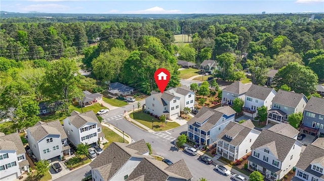 drone / aerial view with a residential view and a wooded view