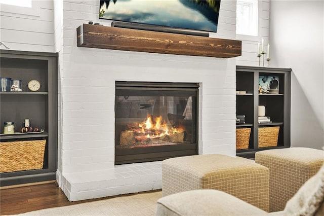 room details featuring a fireplace and wood finished floors