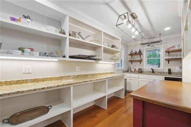 kitchen with white cabinetry, open shelves, light wood-style floors, and crown molding