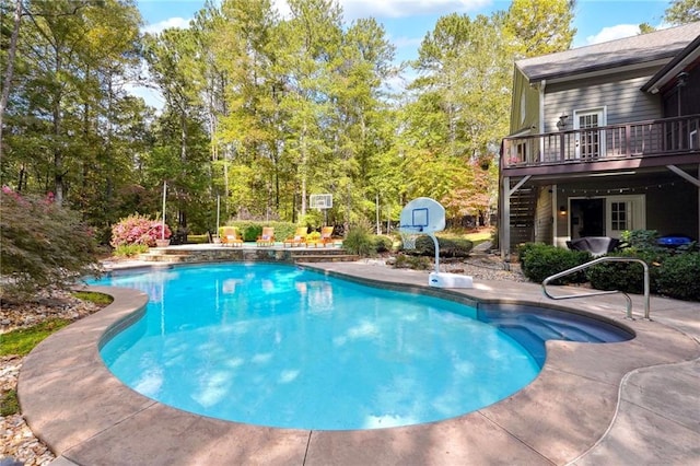pool featuring a wooden deck and a patio area
