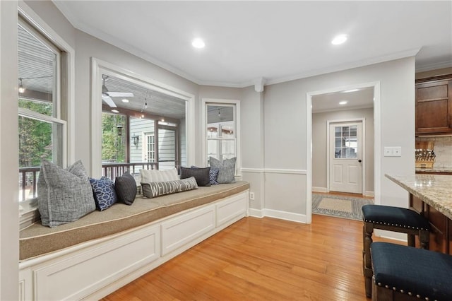 sitting room featuring crown molding, light wood-style floors, and recessed lighting