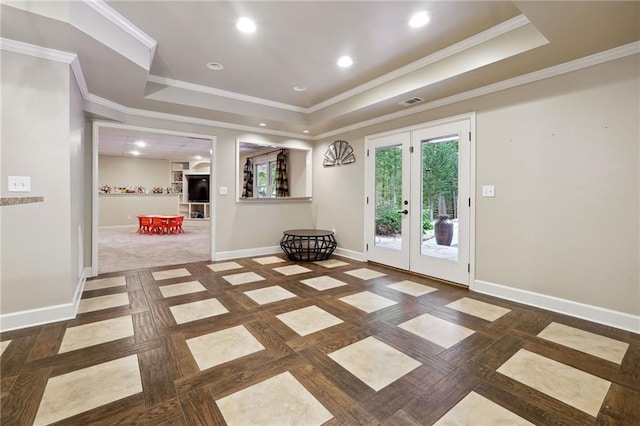 interior space with crown molding, a tray ceiling, recessed lighting, french doors, and baseboards