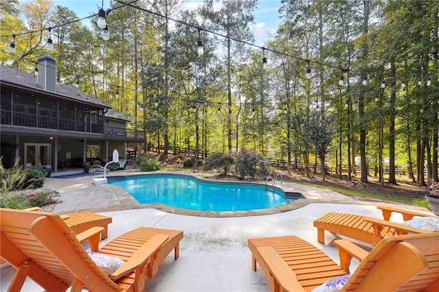 pool with french doors and a patio