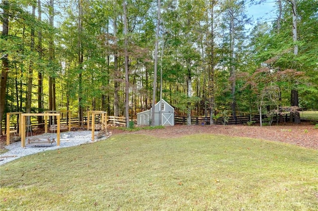 view of yard featuring an outbuilding, fence, and a barn