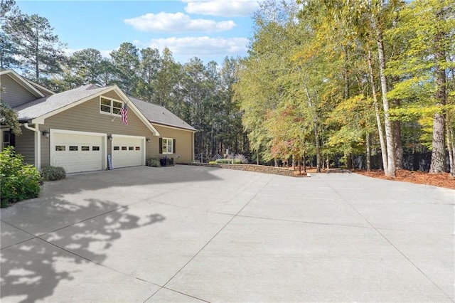 view of home's exterior featuring driveway and a garage