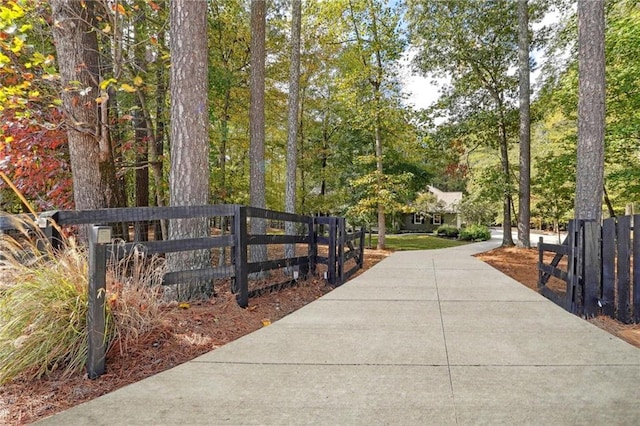 surrounding community featuring driveway and fence