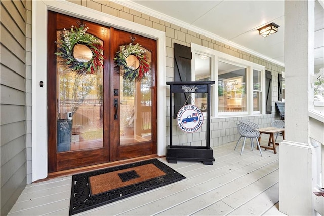 doorway to property featuring covered porch