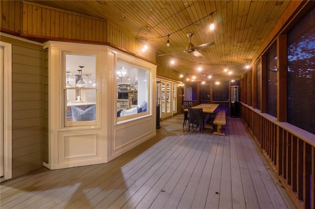 wooden deck featuring outdoor dining space and ceiling fan