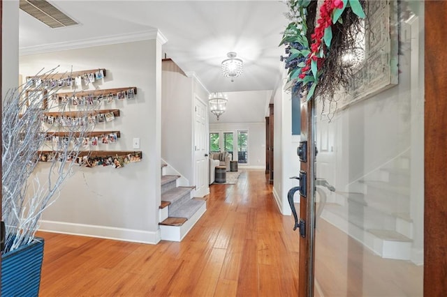 entryway with baseboards, stairs, visible vents, and light wood finished floors
