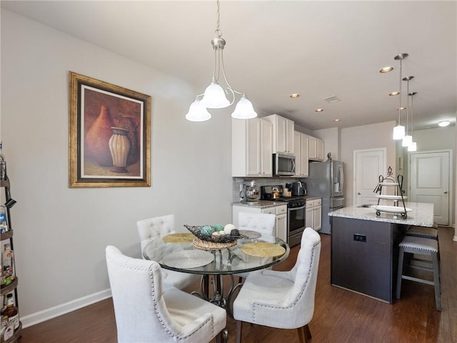 dining space with recessed lighting, baseboards, and dark wood-style flooring